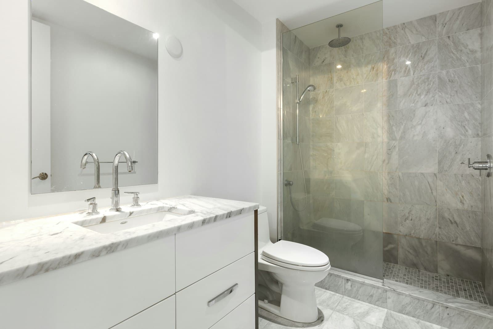 Renovated bathroom with a frameless glass shower